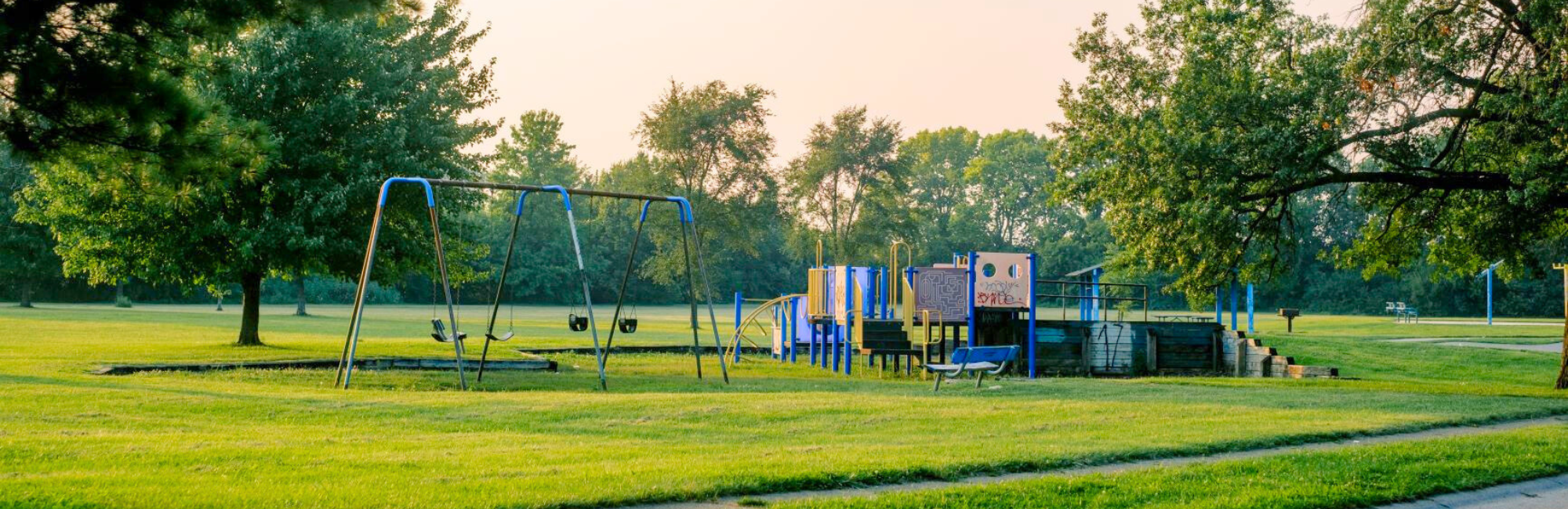 park with a playground and swingset in the distance