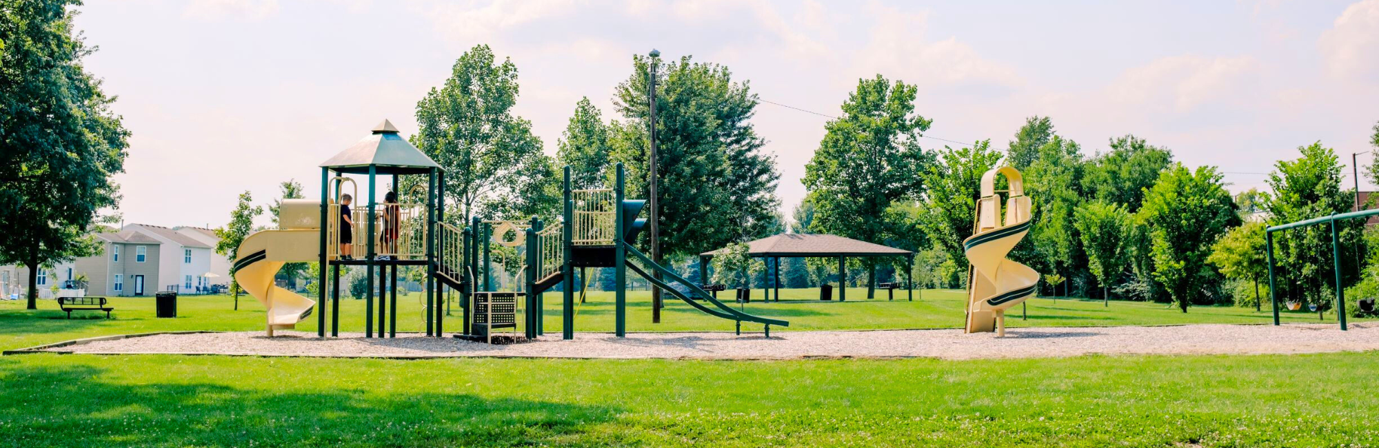 park in a neighborhood with a playground and a shelter