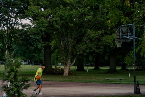 Person playing basketball at park