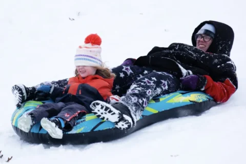 Person sledding at Rhodius Park