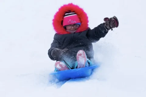 Child sledding at Rhodius Park