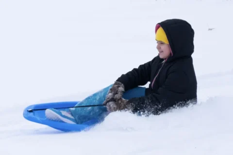 Child sledding at Rhodius Park